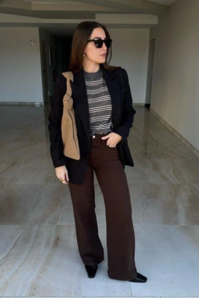 Woman wearing brown jeans with a beige blazer and white shirt for a polished smart casual outfit