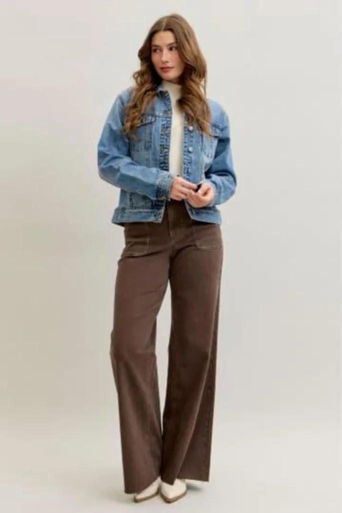 Woman wearing brown jeans with a light blue denim jacket and white t-shirt for a casual outfit