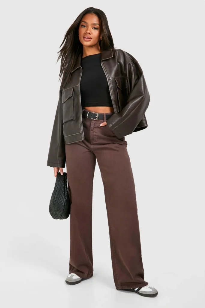Woman wearing brown jeans with a black leather jacket and boots for an edgy casual outfit
