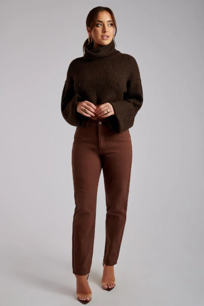 Woman wearing brown jeans with a camel sweater and tan boots in a stylish monochrome brown outfit