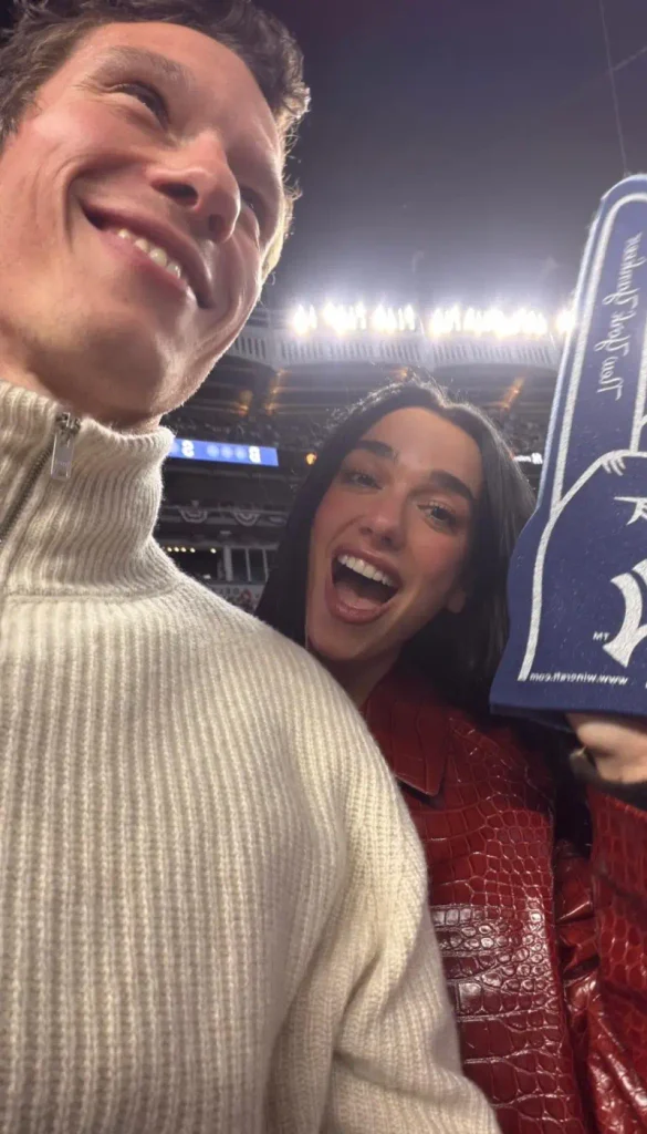 Dua Lipa and Callum Turner enjoying a New York Yankees baseball game together.