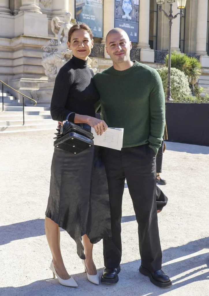 Jason Bard Yarmosky wearing a forest green sweater with black trousers and dress shoes