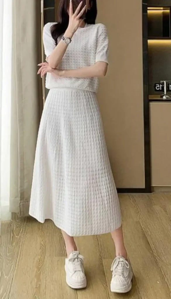 White two-piece knit skirt outfit styled with sneakers for casual days.