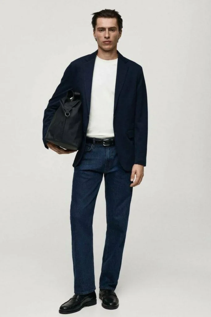 Man wearing a navy blazer with a casual smart outfit