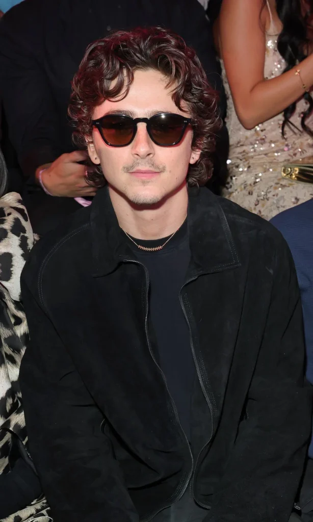 Male celebrity guest wearing a black outfit and dark sunglasses at the 2026 Victoria’s Secret Fashion Show.